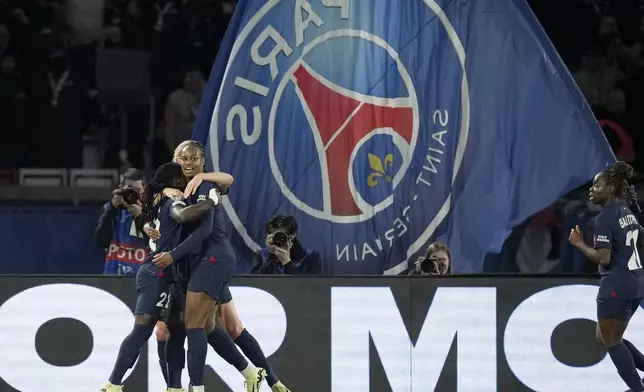 PSG's Tabitha Chawinga, left, celebrates with her teammates after scoring the opening goal during the women's Champions League quarterfinals, second leg, soccer match between Paris Saint-Germain and BK Hacken at Parc des Princes, in Paris, Thursday, March 28, 2024. (AP Photo/Thibault Camus)