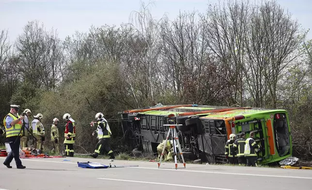A coach lies overturned on its side at the scene of an accident on the A9, near Schkeuditz, Germany, Wednesday March 27. 2024. (Jan Woitas/dpa via AP)