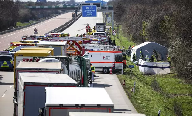 Emergency vehicles and rescue helicopters are at the scene of the accident on the A9, near Schkeuditz, Germany, Wednesday March 27. 2024. (Jan Woitas/dpa via AP)