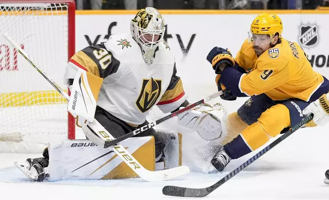 Vegas Golden Knights goaltender Jiri Patera (30) deflects a shot on goal by Nashville Predators left wing Filip Forsberg (9) during the second period of an NHL hockey game Tuesday, March 26, 2024, in Nashville, Tenn. (AP Photo/George Walker IV)
