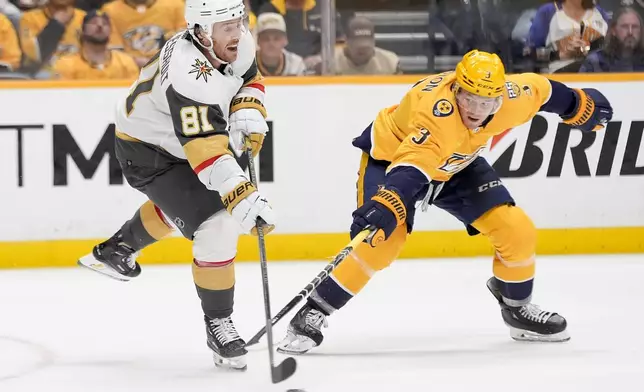 Vegas Golden Knights right wing Jonathan Marchessault (81) passes the puck past Nashville Predators defenseman Jeremy Lauzon (3) during the second period of an NHL hockey game Tuesday, March 26, 2024, in Nashville, Tenn. (AP Photo/George Walker IV)