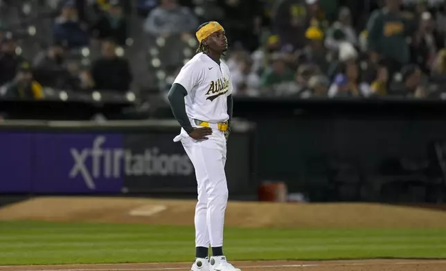 Oakland Athletics' Lawrence Butler reacts after being tagged out at third base on a throw by Cleveland Guardians right fielder Ramón Laureano during the fifth inning of a baseball game Thursday, March 28, 2024, in Oakland, Calif. (AP Photo/Godofredo A. Vásquez)