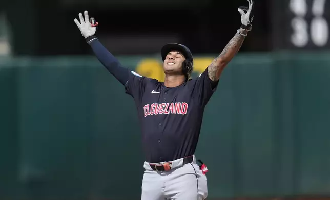 Cleveland Guardians' Brayan Rocchio gestures after hitting a double against the Oakland Athletics during the fourth inning of a baseball game in Oakland, Calif., Saturday, March 30, 2024. (AP Photo/Jeff Chiu)