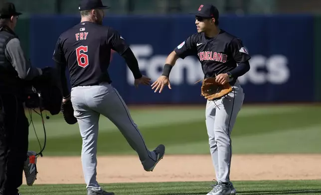 Cleveland Guardians' David Fry, left, celebrates with Steven Kwan after the Guardians defeated the Oakland Athletics in a baseball game in Oakland, Calif., Saturday, March 30, 2024. (AP Photo/Jeff Chiu)