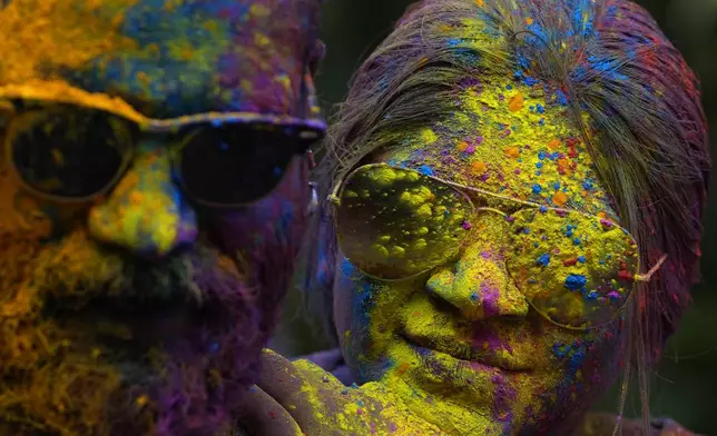 Faces of a couple are smeared with colored powder as they celebrate Holi, the Hindu festival of colors, in Mumbai, India, Monday, March 25, 2024. (AP Photo/Rafiq Maqbool)