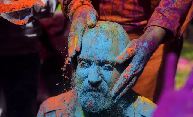 Indians smear colored powder on each other as they celebrate Holi in Jammu, India, Monday, March.25, 2024.The Hindu festival of colors, also heralds the arrival of spring.(AP Photo/Channi Anand)