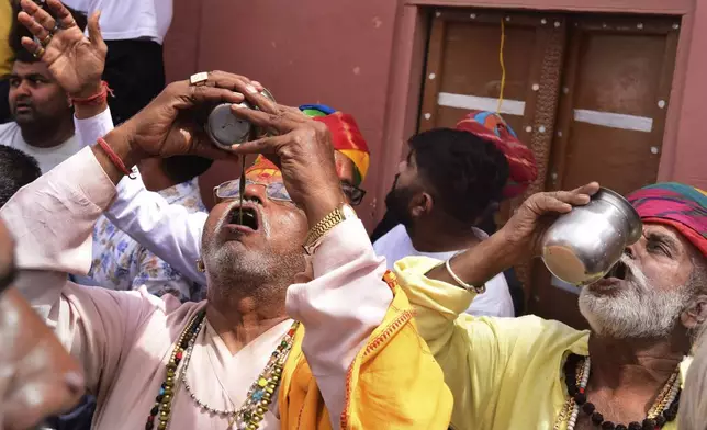 People drink Bhang, a beverage prepared with milk, dry fruits and cannabis, during Holi festivities in Bikaner, in the Indian state of Rajasthan, India, Thursday, March 21, 2024. Holi, the Hindu festival of colors that also heralds the coming of spring, is being celebrated across the country Monday. Bhang is a popular drink during Holi. (AP Photo/Dinesh Gupta)