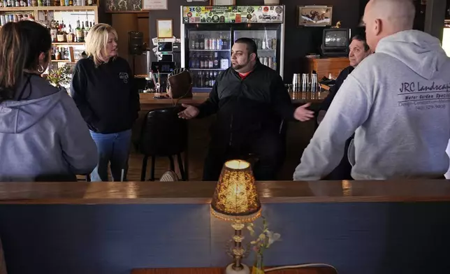 Steven Costa, center, owner and chef at Rosa's Tavern, gathers with other local business owners impacted by the closing of the Washington Bridge, due to failure of some bridge components, Friday, March 8, 2024, in East Providence, R.I. The closure of a section of the bridge, and onramps, has caused a significant loss to the group's revenue. (AP Photo/Charles Krupa)