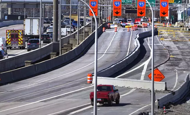 Diverted traffic, including an ambulance on a call, passes a closed portion of the Washington Bridge, Friday, March 8, 2024, in East Providence, R.I. The closure of a section of the bridge, and onramps, due to failure of some bridge components, has caused a significant loss to local businesses. (AP Photo/Charles Krupa)