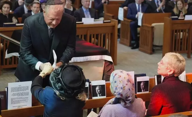 Former Vice President Al Gore offers his condolences to Hadassah Lieberman during the funeral for her husband, former Sen. Joe Lieberman in Stamford, Conn., Friday, March. 29, 2024. (AP Photo/Bryan Woolston)