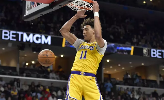 Los Angeles Lakers center Jaxson Hayes dunks against the Memphis Grizzlies during the first half of an NBA basketball game Wednesday, March 27, 2024, in Memphis, Tenn. (AP Photo/Brandon Dill)