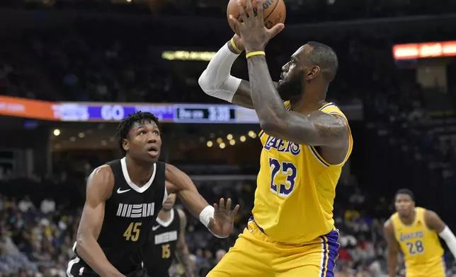 Los Angeles Lakers forward LeBron James (23) shoots against Memphis Grizzlies forward GG Jackson II (45) during the first half of an NBA basketball game Wednesday, March 27, 2024, in Memphis, Tenn. (AP Photo/Brandon Dill)