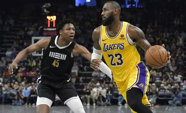 Los Angeles Lakers forward LeBron James (23) drives against Memphis Grizzlies forward GG Jackson II (45) during the first half of an NBA basketball game Wednesday, March 27, 2024, in Memphis, Tenn. (AP Photo/Brandon Dill)
