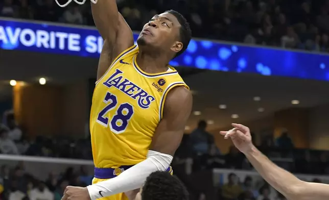 Los Angeles Lakers forward Rui Hachimura (28) dunks over Memphis Grizzlies guard Scotty Pippen Jr. (1) in the first half of an NBA basketball game Wednesday, March 27, 2024, in Memphis, Tenn. (AP Photo/Brandon Dill)