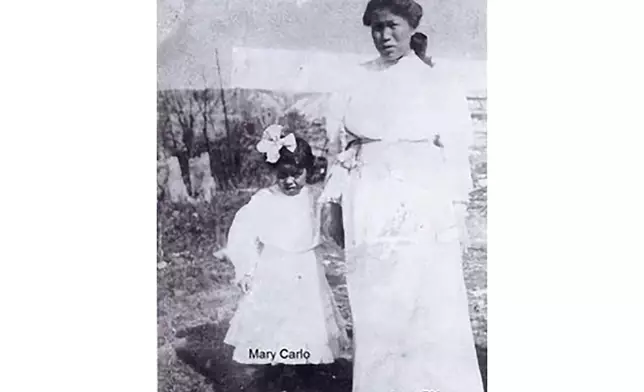 In this photo believed taken in 1925, Lucille Pitka McCormick, right, is shown with her daughter Mary Carlo in the village of Rampart, Alaska. McCormick was one of the Lost Alaskans sent to a mental hospital in the 1930s. Her grave was recently discovered, and family members brought her back to Alaska for a proper burial. (Photo by Wally Carlo via AP).