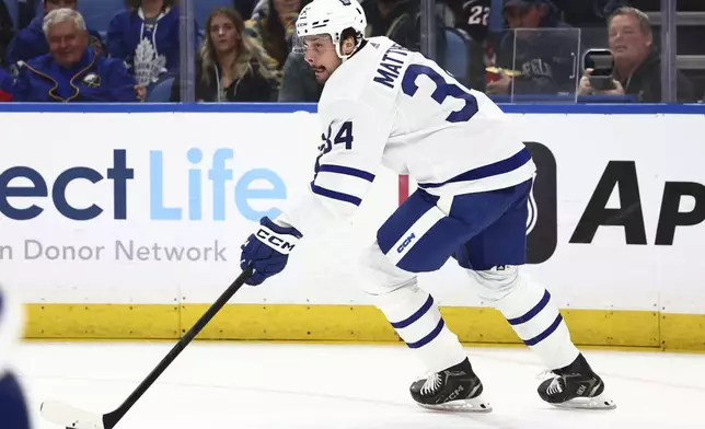 Toronto Maple Leafs center Auston Matthews (34) carries the puck up ice during the first period of an NHL hockey game against the Buffalo Sabres, Saturday, March 30, 2024, in Buffalo, N.Y. (AP Photo/Jeffrey T. Barnes)