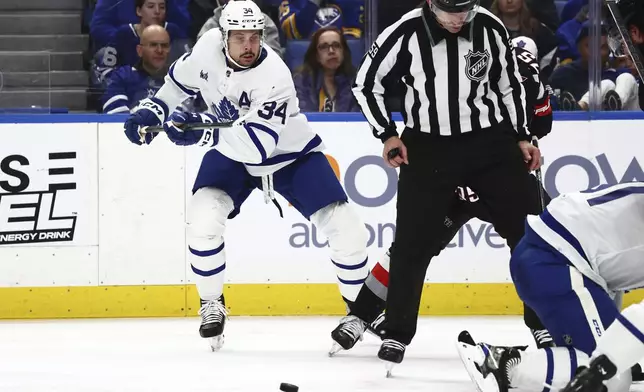 Toronto Maple Leafs center Auston Matthews (34) skates toward a loose puck during the second period of an NHL hockey game against the Buffalo Sabres, Saturday, March 30, 2024, in Buffalo, N.Y. (AP Photo/Jeffrey T. Barnes)