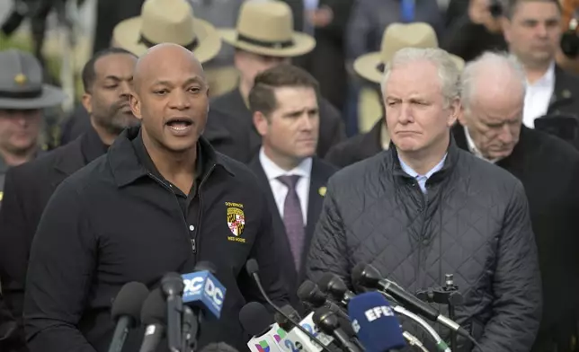 Maryland Gov. Wes Moore, left, speaks during a news conference as Sen. Chris Van Hollen (D-MD) looks on near the scene where a container ship collided with a support on the Francis Scott Key Bridge, Tuesday, March 26, 2024 in Baltimore. The major bridge in Baltimore snapped and collapsed after a container ship rammed into it early Tuesday, and several vehicles fell into the river below. Rescuers were searching for multiple people in the water. (AP Photo/Steve Ruark)