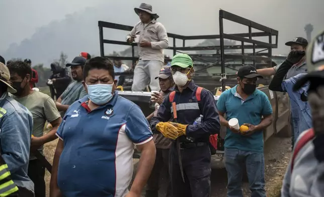 Villagers arrive to take part in efforts to contain a wildfire in Nogales, in the High Mountains area of Veracruz state, Mexico, Monday, March 25, 2024. (AP Photo/Felix Marquez)
