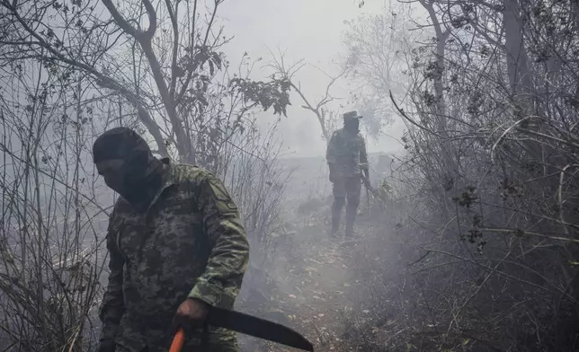 Soldiers work to contain wildfires in Nogales, in the High Mountains area of Veracruz state, Mexico, Monday, March 25, 2024.(AP Photo/Felix Marquez)