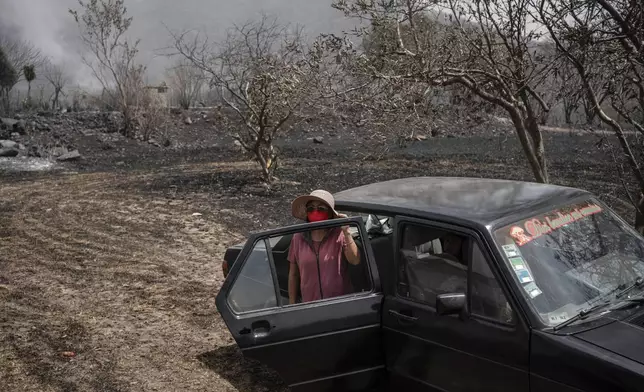Catalina Villafuerte watches her farm burned by wildfires in Maltrata, in the High Mountains area of Veracruz state, Mexico, Monday, March 25, 2024. (AP Photo/Felix Marquez)