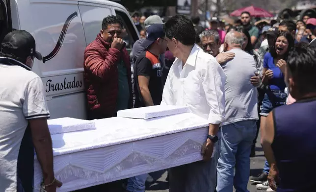 Funeral workers carry the coffin that contain the remains of an 8-year-old girl, in Taxco, Mexico, Thursday, March 28, 2024. The 8-year-old girl disappeared Wednesday; her body was found on a road on the outskirts of the city early Thursday. (AP Photo/Fernando Llano)