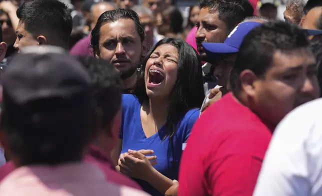 A relative of an 8-year-old girl, who was kidnapped the previous day, weeps as her body is handed over to family in Taxco, Mexico, Thursday, March 28, 2024. (AP Photo/Fernando Llano)