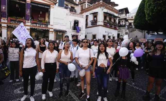 Women chant the word "justice" during a demonstration protesting the kidnapping and killing of an 8-year-old girl, in the main square of Taxco, Mexico, Thursday, March 28, 2024. Hours earlier a mob beat a woman to death because she was suspected of kidnapping and killing the young girl. (AP Photo/Fernando Llano)