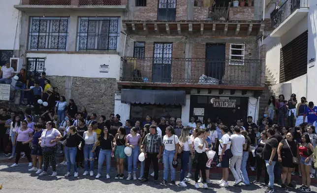 Residents gather as the coffin that contain the remains of an 8-year-old girl is delivered to family, in Taxco, Mexico, Thursday, March 28, 2024. The 8-year-old girl disappeared Wednesday; her body was found on a road on the outskirts of the city early Thursday. (AP Photo/Fernando Llano)