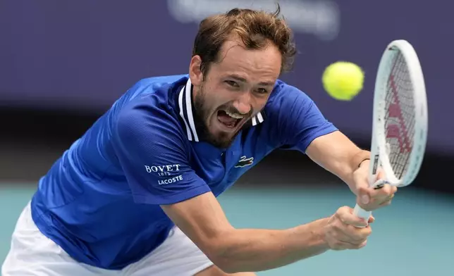 Daniil Medvedev, of Russia, hits a return to Jannik Sinner, of Italy, during a semifinal match at the Miami Open tennis tournament, Friday, March 29, 2024, in Miami Gardens, Fla. (AP Photo/Lynne Sladky)