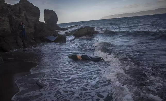 FILE - The lifeless body of an unidentified woman washes up on the shoreline at the village of Skala, on the Greek island of Lesbos, on Sunday, Nov. 1, 2015. The UN migration agency marks a decade since the launch of the Missing Migrants Project, documenting more than 63,000 deaths around the world. More than two-thirds of victims remain unidentified highlighting the size of the crisis and the suffering of families who rarely receive definitive answers. (AP Photo/Santi Palacios, File)