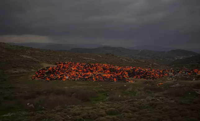 FILE - Piles of life jackets used by refugees and migrants to cross the Aegean sea from the Turkish coast remain stacked on the northeastern Greek island of Lesbos, on Wednesday, Dec. 16, 2015. The UN migration agency marks a decade since the launch of the Missing Migrants Project, documenting more than 63,000 deaths around the world. More than two-thirds of victims remain unidentified highlighting the size of the crisis and the suffering of families who rarely receive definitive answers. (AP Photo/Santi Palacios, File)