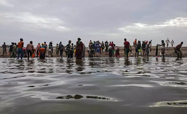 FILE - Ethiopian migrants walk on the shores of Ras al-Ara, Lahj, Yemen, after disembarking from a boat, July 26, 2019. The UN migration agency marks a decade since the launch of the Missing Migrants Project, documenting more than 63,000 deaths around the world. More than two-thirds of victims remain unidentified highlighting the size of the crisis and the suffering of families who rarely receive definitive answers. (AP Photo/Nariman El-Mofty, File)