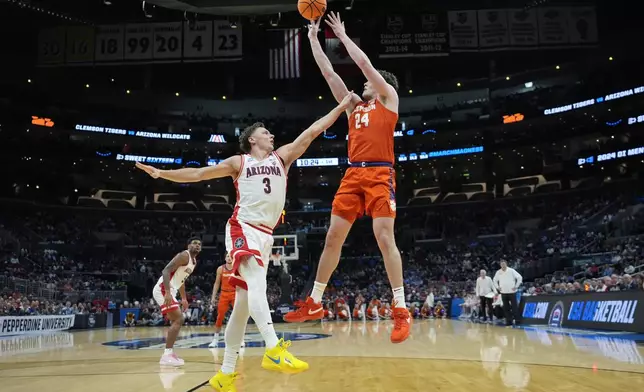 Clemson center PJ Hall (24) shoots over Arizona guard Pelle Larsson (3) during the first half of a Sweet 16 college basketball game in the NCAA tournament Thursday, March 28, 2024, in Los Angeles. (AP Photo/Ashley Landis)