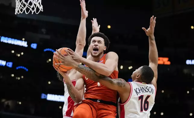 Clemson guard Chase Hunter (1) drives past Arizona forward Keshad Johnson (16) during the first half of a Sweet 16 college basketball game in the NCAA tournament Thursday, March 28, 2024, in Los Angeles. (AP Photo/Ashley Landis)