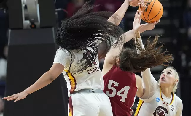 South Carolina center Kamilla Cardoso (10) and forward Chloe Kitts (21) block a shot attempt by Indiana forward Mackenzie Holmes (54) during the first half of a Sweet Sixteen round college basketball game during the NCAA Tournament, Friday, March 29, 2024, in Albany, N.Y. (AP Photo/Mary Altaffer)