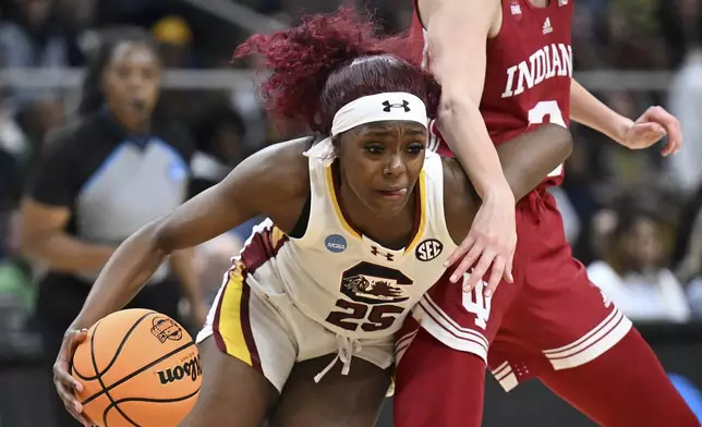 South Carolina guard Raven Johnson (25) drives around Indiana guard Yarden Garzon (12) during the first half of a Sweet Sixteen round college basketball game during the NCAA Tournament, Friday, March 29, 2024, in Albany, N.Y. (AP Photo/Hans Pennink)