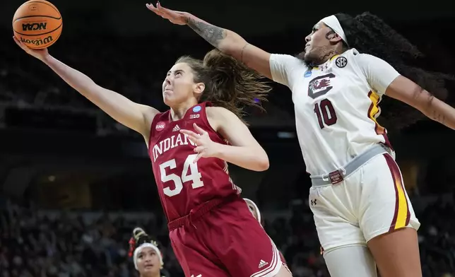 Indiana forward Mackenzie Holmes (54) puts up a shot against South Carolina center Kamilla Cardoso (10) during the second half of a Sweet Sixteen round college basketball game during the NCAA Tournament, Friday, March 29, 2024, in Albany, N.Y. (AP Photo/Mary Altaffer)