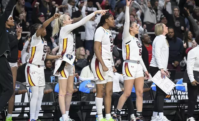 South Carolina guard MiLaysia Fulwiley (12), forward Chloe Kitts (21), forward Sania Feagin (20) and guard Tessa Johnson (5) react during the second half of a Sweet Sixteen round college basketball game during the NCAA Tournament, Friday, March 29, 2024, in Albany, N.Y. (AP Photo/Hans Pennink)