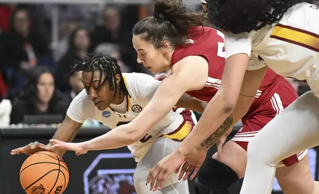 South Carolina forward Ashlyn Watkins (2) and Indiana forward Mackenzie Holmes (54) scramble for a loose ball during the first quarter of a Sweet Sixteen round college basketball game during the NCAA Tournament, Friday, March 29, 2024, in Albany, N.Y. (AP Photo/Hans Pennink)