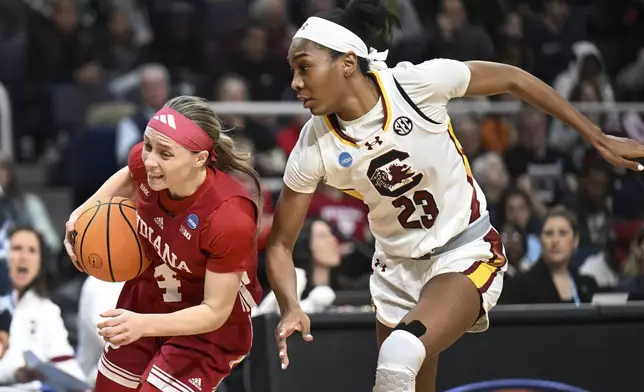 Indiana guard Sara Scalia (14) drives against South Carolina guard Bree Hall (23) during the first quarter of a Sweet Sixteen round college basketball game during the NCAA Tournament, Friday, March 29, 2024, in Albany, N.Y. (AP Photo/Hans Pennink)