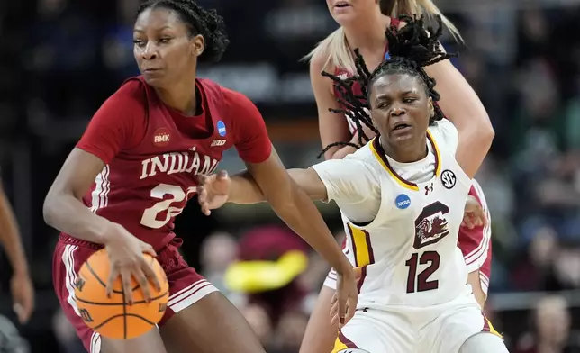 South Carolina guard MiLaysia Fulwiley (12) tries to strip the ball from Indiana guard Chloe Moore-McNeil (22) during the first quarter of a Sweet Sixteen round college basketball game during the NCAA Tournament, Friday, March 29, 2024, in Albany, N.Y. (AP Photo/Mary Altaffer)