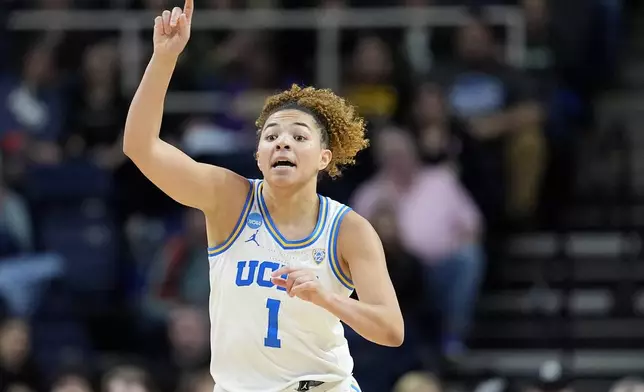UCLA guard Kiki Rice (1) motions to teammates during the second quarter of a Sweet Sixteen round college basketball game against the LSU during the NCAA Tournament, Saturday, March 30, 2024, in Albany, N.Y. (AP Photo/Mary Altaffer)