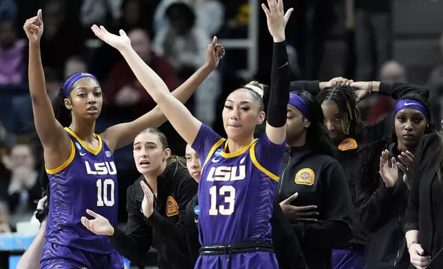 LSU guard Last-Tear Poa (13) and forward Angel Reese (10) react with teammates during the third quarter of a Sweet Sixteen round college basketball game against UCLA during the NCAA Tournament, Saturday, March 30, 2024, in Albany, N.Y. (AP Photo/Mary Altaffer)