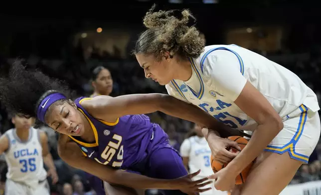 LSU forward Angel Reese (10) and UCLA center Lauren Betts (51) fight for control of the ball during the second quarter of a Sweet Sixteen round college basketball game during the NCAA Tournament, Saturday, March 30, 2024, in Albany, N.Y. (AP Photo/Mary Altaffer)