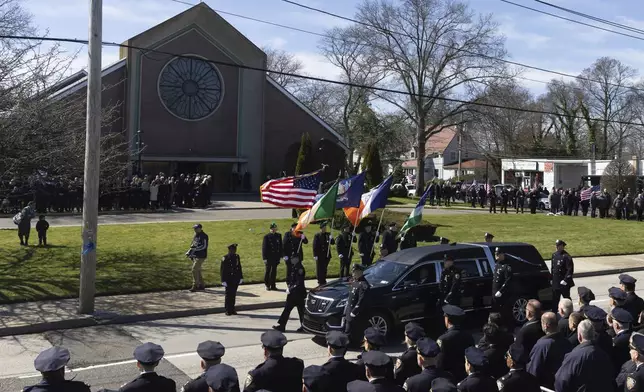 The casket containing New York Ciity Police department officer Jonathan Diller's body arrives at Saint Rose of Lima R.C Church in Massapequa Park, N.Y., on Saturday, March 30, 2024. Diller was shot dead Monday during a traffic stop. He was the first New York City police officer killed in the line of duty in two years.(AP Photo/Jeenah Moon)
