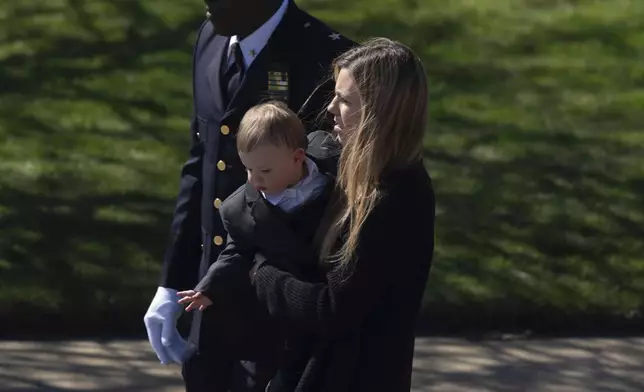 Jonathan Diller 's wife Stephanie Diller and her son arrive during a funeral service for New York City Police Department officer Jonathan Diller at Saint Rose of Lima R.C Church in Massapequa Park, N.Y., on Saturday, March 30, 2024. Diller was shot dead Monday during a traffic stop. He was the first New York City police officer killed in the line of duty in two years.(AP Photo/Jeenah Moon)