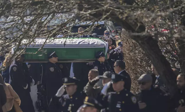 Police officers carry the casket during a funeral service for New York City Police Department officer Jonathan Diller at Saint Rose of Lima R.C Church in Massapequa Park, N.Y., on Saturday, March 30, 2024. Diller was shot dead Monday during a traffic stop. He was the first New York City police officer killed in the line of duty in two years.(AP Photo/Jeenah Moon)