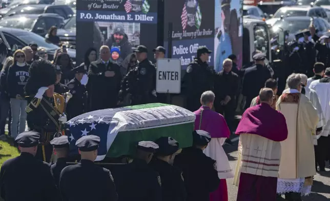 Police officers carry the casket during a funeral service for New York City Police Department officer Jonathan Diller at Saint Rose of Lima R.C Church in Massapequa Park, N.Y., on Saturday, March 30, 2024. Diller was shot dead Monday during a traffic stop. He was the first New York City police officer killed in the line of duty in two years.(AP Photo/Jeenah Moon)