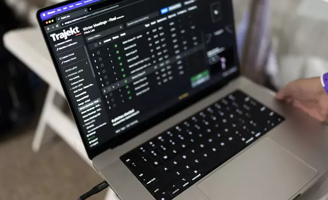 A laptop is used to demonstrate the Trajekt Arc pitching machine during the Major League Baseball winter meetings Wednesday, Dec. 6, 2023, in Nashville, Tenn. (AP Photo/George Walker IV)